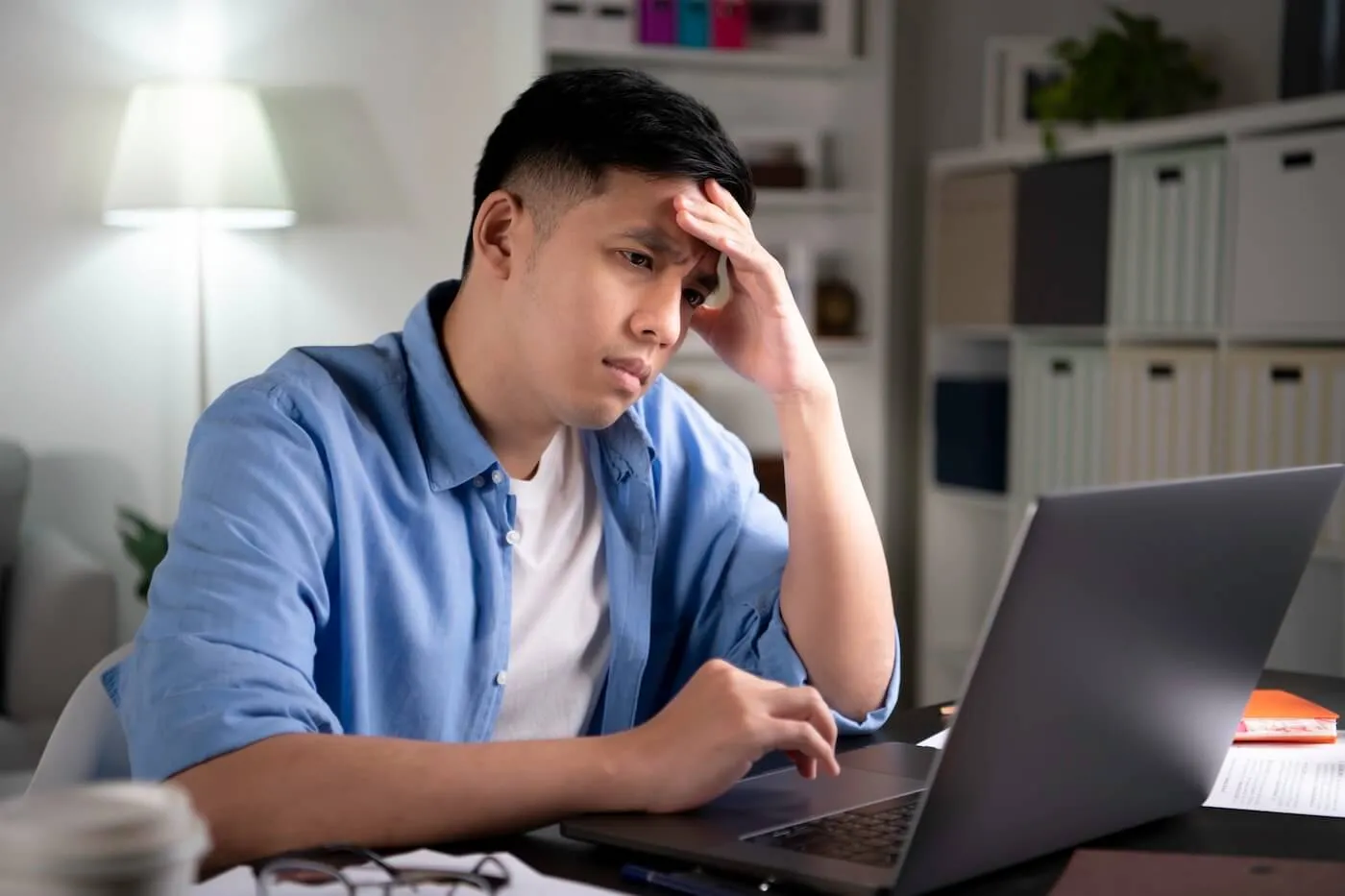 Concerned young man using his laptop