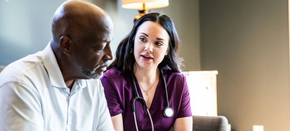 nurse talking to patient in room